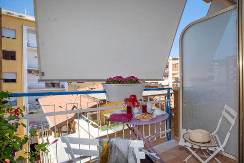a balcony with a table and chairs on a balcony at Viria B&B Sorrento in Sorrento