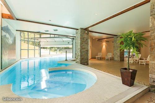 a large swimming pool in a large house at T2 RESIDENCE 3 ETOILES Piscine chauffée Sauna Hammam in Cauterets