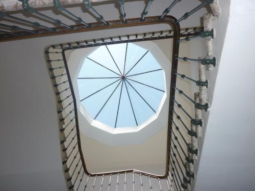 a mirror hanging on a wall with a metal frame at Chez Albert et Karine in Sauve