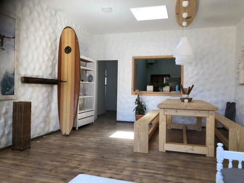a living room with a surfboard on the wall at Wellenkind Surfschool in La Pared