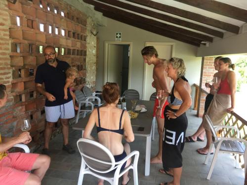 a group of people standing around a table with wine glasses at Tenuta San Giovanni Lucca in Lucca