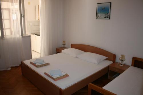a bedroom with a bed with two plates on it at Apartments Vili Betina in Betina