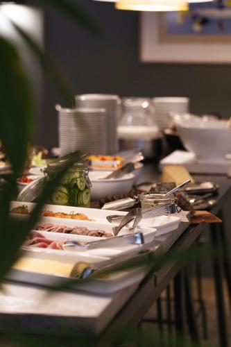 a table with plates of food on top of it at Hotel St. George Helsinki in Helsinki