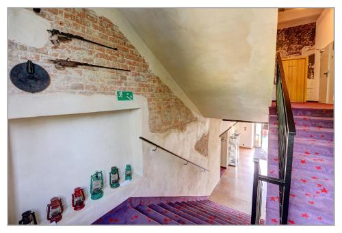 a room with a staircase and a brick wall at Koszary Arche Hotel in Góra Kalwaria