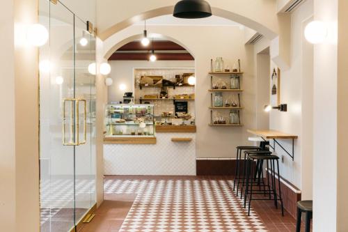 an archway leads into a restaurant with a bar at Hotel St. George Helsinki in Helsinki