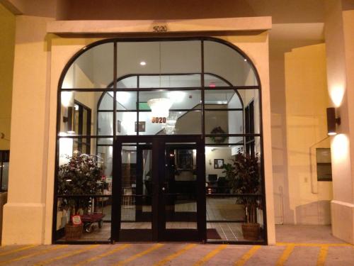 an entrance to a building with a large glass door at Brentwood Inn & Suites in Hobbs