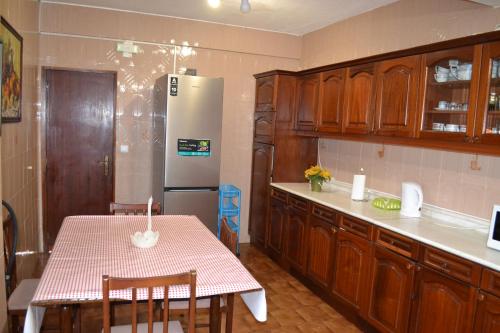 a kitchen with a table and a refrigerator at Casa Amado in Lagos