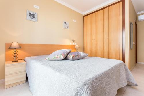 ポルティマンにあるEdificio Sol Matos Apartmentのベッドルーム1室(白いベッド1台、枕2つ付)
