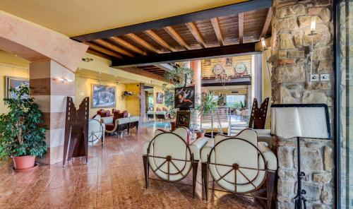 a lobby with chairs and a stone wall at Art & Hotel Aeroporto in Stezzano