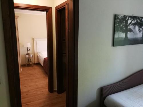 an open door to a bedroom with a bed at Locanda Tre Frati in Pescocostanzo