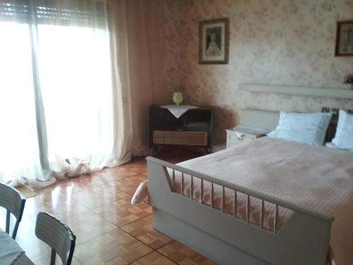 a bedroom with a large bed and a chair at Maisonette Afroditi in Perea