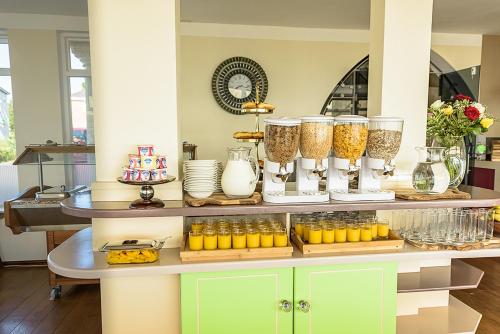 a counter with a bunch of vases on it at Villa Mentone Hotel in Shanklin
