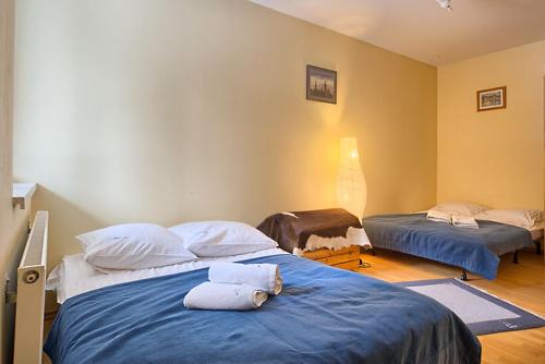 a bedroom with two beds with towels on them at VisitZakopane - Nosal Apartment in Zakopane