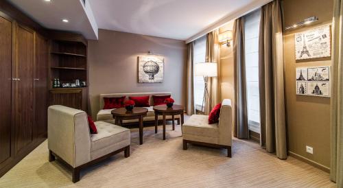 a living room with two chairs and a table and a couch at Airport Hotel Okęcie in Warsaw