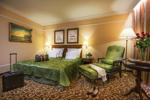 Habitación de hotel con cama y silla en Carlsbad Plaza Medical Spa & Wellness hotel en Karlovy Vary