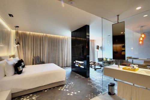 a hotel room with a bed and a bathroom at Radisson Bengaluru City Center in Bengaluru
