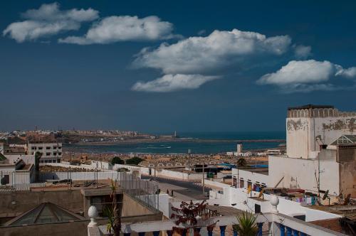 a view of a city with the ocean and buildings at Riad Dar Jabador in Sale