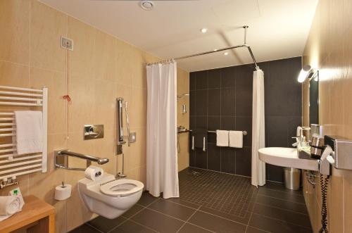 a bathroom with a toilet and a shower and a sink at Hotel Bildungsblick in Kirchseeon