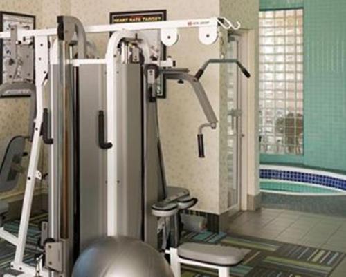 a bathroom with a swimming pool and a room with a tub at Inn At The Quay in New Westminster