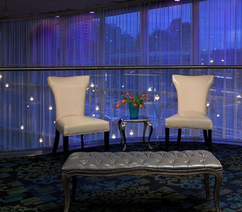 two chairs and a table with a vase of flowers at Inn At The Quay in New Westminster