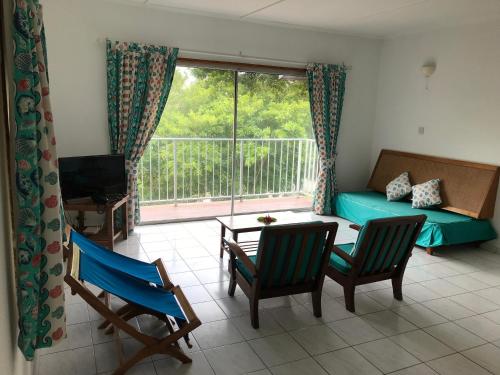 a living room with a couch and a table and chairs at Michel Holiday Apartments in Victoria