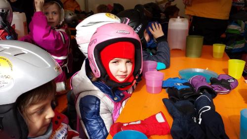 a group of children wearing helmets on a table at House Arianna in Bad Kleinkirchheim