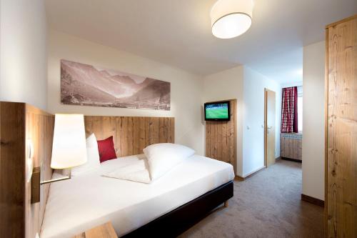 Ένα ή περισσότερα κρεβάτια σε δωμάτιο στο Hotel Bergland Superior