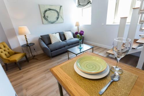 a living room with a table with a plate on it at Casa de la Merced Suites in Málaga