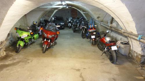 a bunch of motorcycles parked in a tunnel at Hotel des Alpes in Die