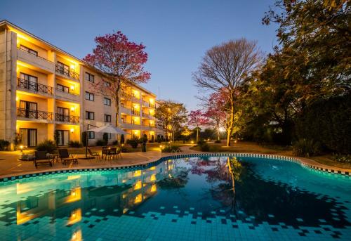 a large swimming pool in front of a building at Hotel Panamby Guarulhos in Guarulhos