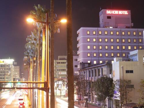 a city street at night with buildings and street lights at Miyazaki Daiichi Hotel in Miyazaki