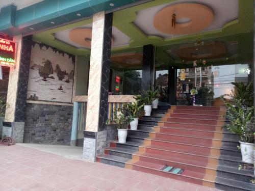 a store front with stairs and potted plants on it at Tuan Tu Hotel in Dong Anh