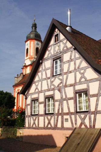 a building with a clock tower in the background at Hotel Riegeler Hof in Riegel