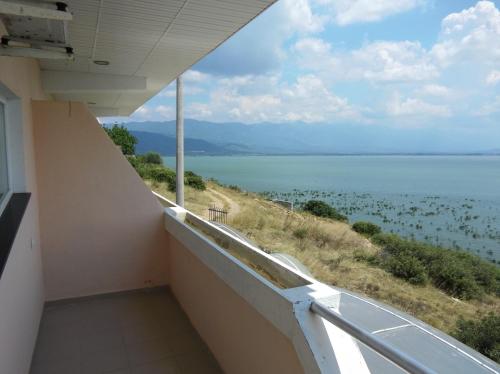 a balcony with a view of the water at Villa Daniela Apartments in Nov Dojran