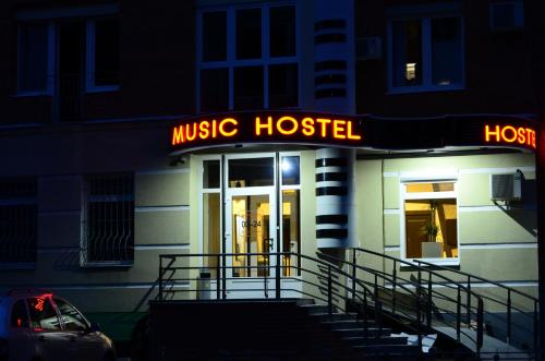 a music house with a neon sign in front of it at Music Hostel in Poltava