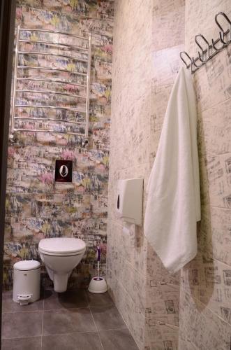 a bathroom with a toilet and a towel at Music Hostel in Poltava