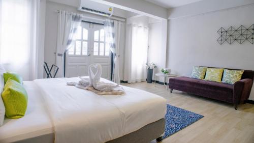 a bedroom with a bed with a bunny on it at Neveu Premier Residence : Ratchada in Bangkok