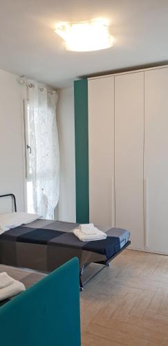 a bedroom with a bed in a room with a window at Roggia Apartments by Quokka 360 - central flats with parking space in Lugano