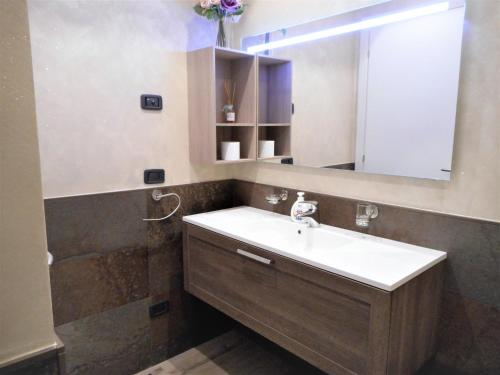 a bathroom with a sink and a mirror at Lago d'Idro - Casa Emma in Ponte Caffaro