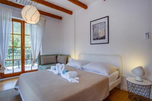 a bedroom with a bed with towels on it at Villa Sveti Jakov in Sveti Jakov