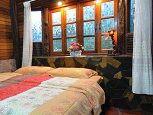 1 dormitorio con cama y ventana en Klongsai Hills, en Wang Nam Khiao