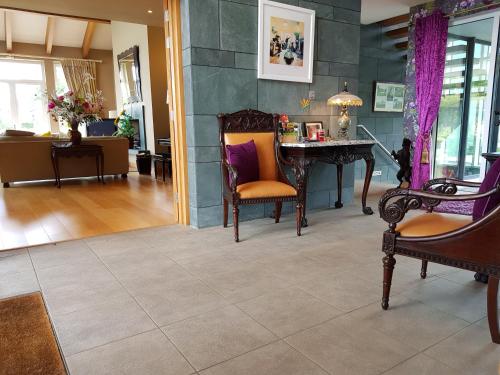 a living room with a table and chairs at Hazelwood Country House in Adare