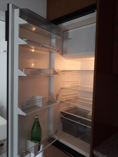 an open refrigerator with a green vase sitting inside at Casa Gudelj in Pirovac
