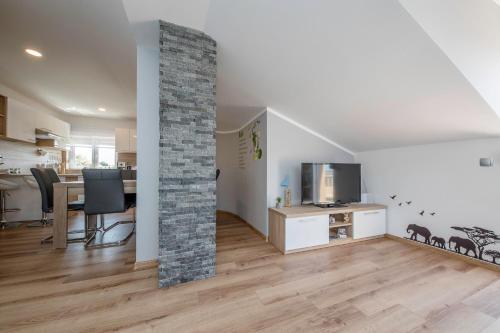 a living room with a stone pillar in a room at Vila Marija in Rab
