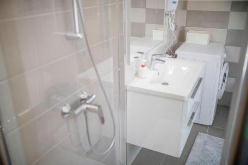 a bathroom with a shower and a sink at Vila Marija in Rab