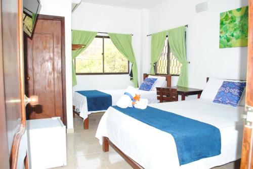 Postel nebo postele na pokoji v ubytování Hotel Ocean Taganga Internacional