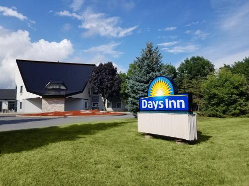 a days inn sign in front of a building at Days Inn by Wyndham Kingston in Kingston