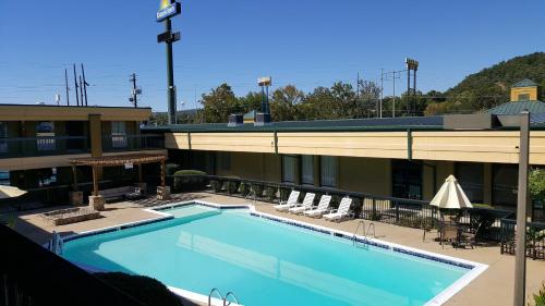 a large swimming pool in front of a hotel at Days Inn by Wyndham Attalla in Attalla