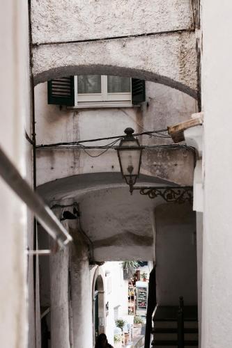 an alley way with a street light and a building at A Passo Duomo in Amalfi