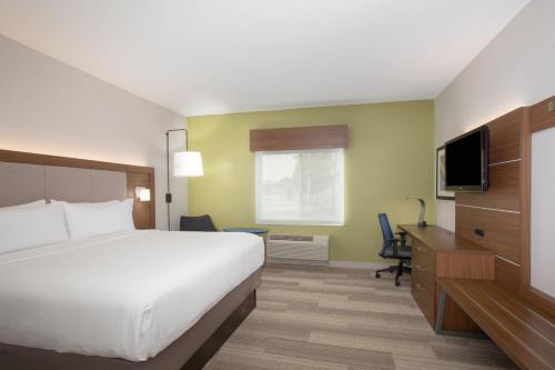 a hotel room with a bed and a television at Holiday Inn Express & Suites Amarillo by IHG in Amarillo
